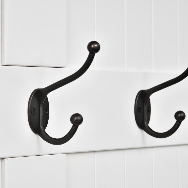 Cream hall tree with black coat hooks and curved mounting brackets
