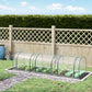 Plastic tunnel greenhouse kit in garden with clear arched cover over planted bed