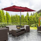 Wine red patio umbrella standing over outdoor seating, center pole visible