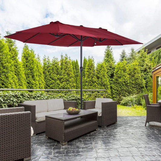 Wine red patio umbrella standing over outdoor seating, center pole visible
