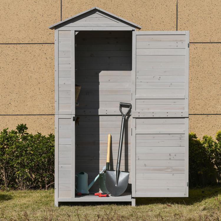 White wooden storage shed cabinet with open doors and gardening tools inside
