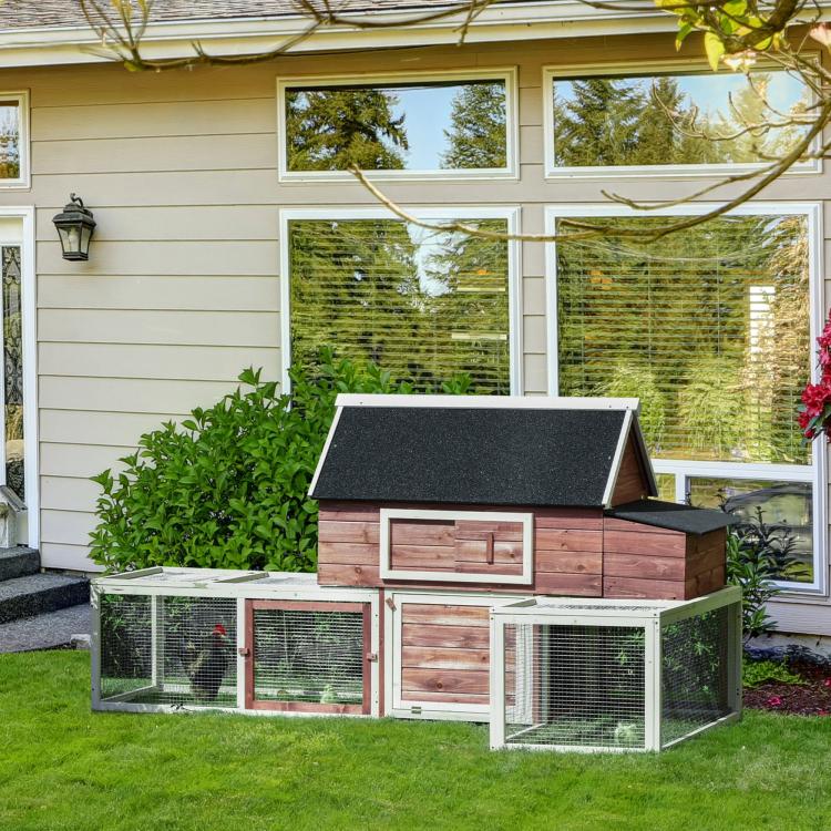 Wooden chicken coop with covered roof and three-section fenced run, door on front
