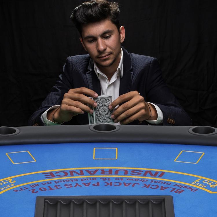 Poker table with blue felt and cup holders, with card tray opening on top