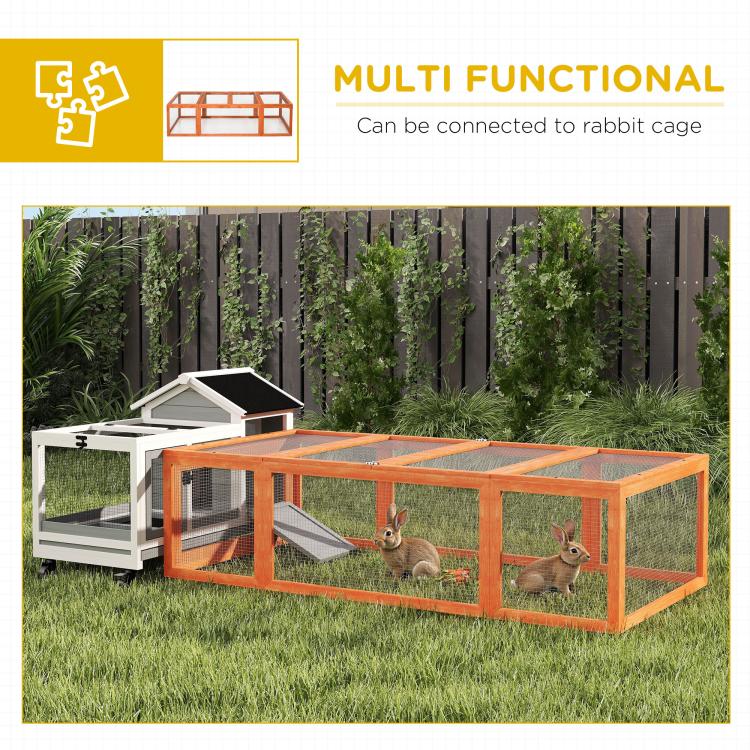 Wooden rabbit hutch enclosure in grass yard with wire mesh sides
