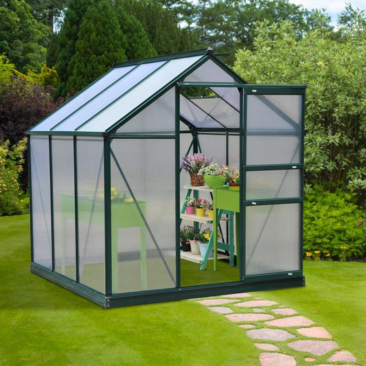 Outdoor dark green greenhouse with clear panels and door opening