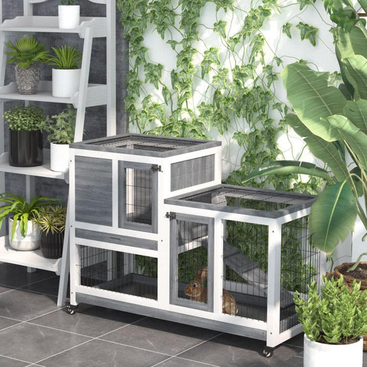 Gray and white indoor rabbit hutch with enclosed run, wire panels, and casters