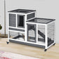 Gray elevated rabbit cage with ramp, wire doors, and wheels for indoor use