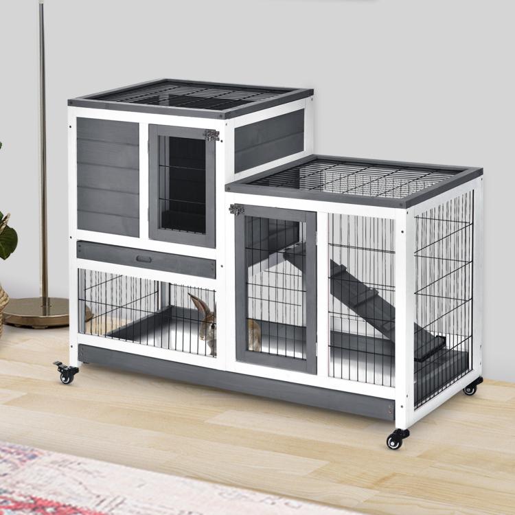 Gray elevated rabbit cage with ramp, wire doors, and wheels for indoor use