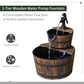 Two-tier wooden water pump fountain with black faucet and flowing water from top barrel