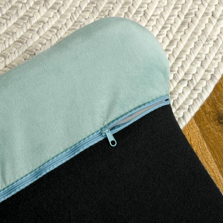Green removable cushion cover with visible zipper and soft fabric texture
