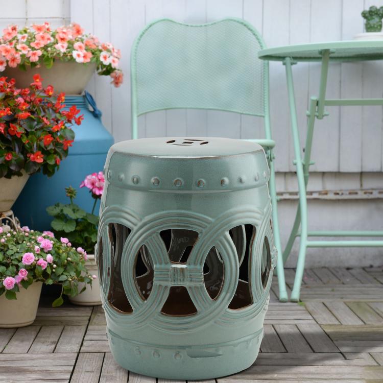 Antique blue ceramic garden stool with glazed double-coin ring cutouts and round lid top.