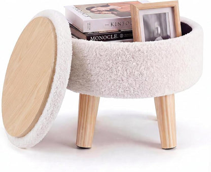 Round beige boucle storage ottoman with wood legs, open lid, and books inside