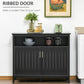 Black ribbed-panel sideboard doors with gold-tone bar handles