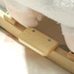 White sheep rocking horse base, plush head partly visible and wooden rocker slats
