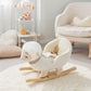 White plush rocking sheep toy with striped scarf on wooden rockers in a nursery.