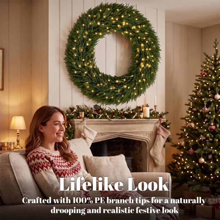 Green lifelike pine wreath with warm white LED lights, displayed above mantel