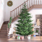 Green artificial Christmas tree with full branch silhouette and wide metal base
