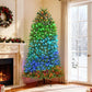 Prelit Christmas tree with green and blue LED lights and black metal stand
