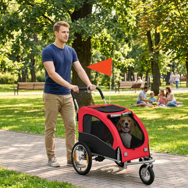 Red dog pet stroller/bike trailer with enclosed mesh sides and black handlebar