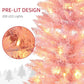 Pink Christmas tree branch close-up with warm white LED lights