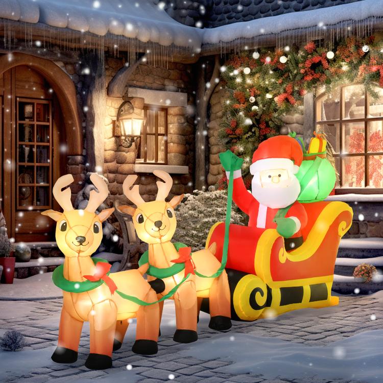 Inflatable Santa and reindeer yard decoration on sleigh, glowing lights outdoors