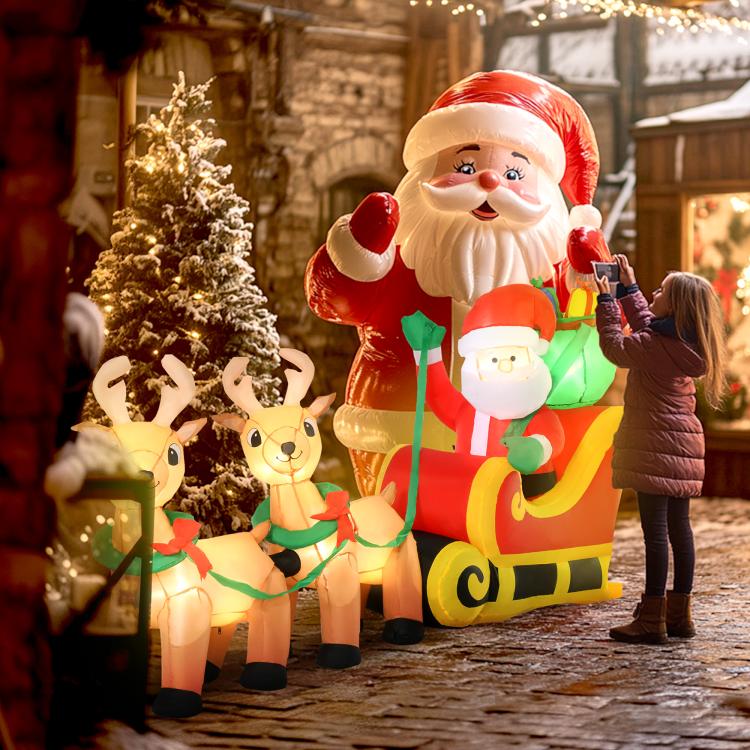 Inflatable Santa and two reindeer on red sleigh, with glowing LED lights