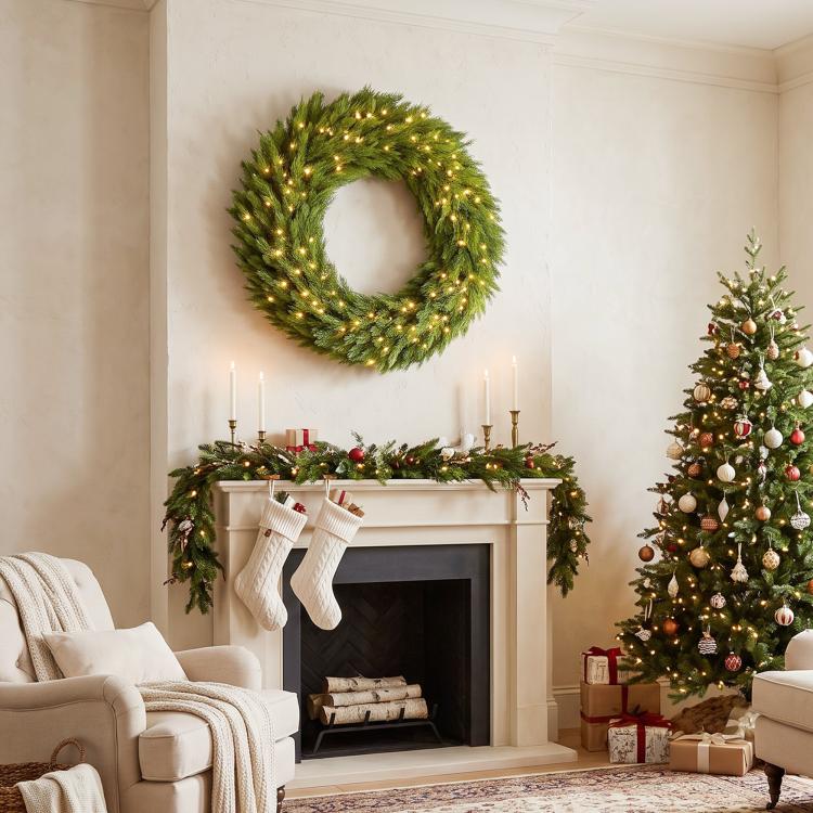 Pre-lit artificial Christmas wreath with green needles and warm LED lights