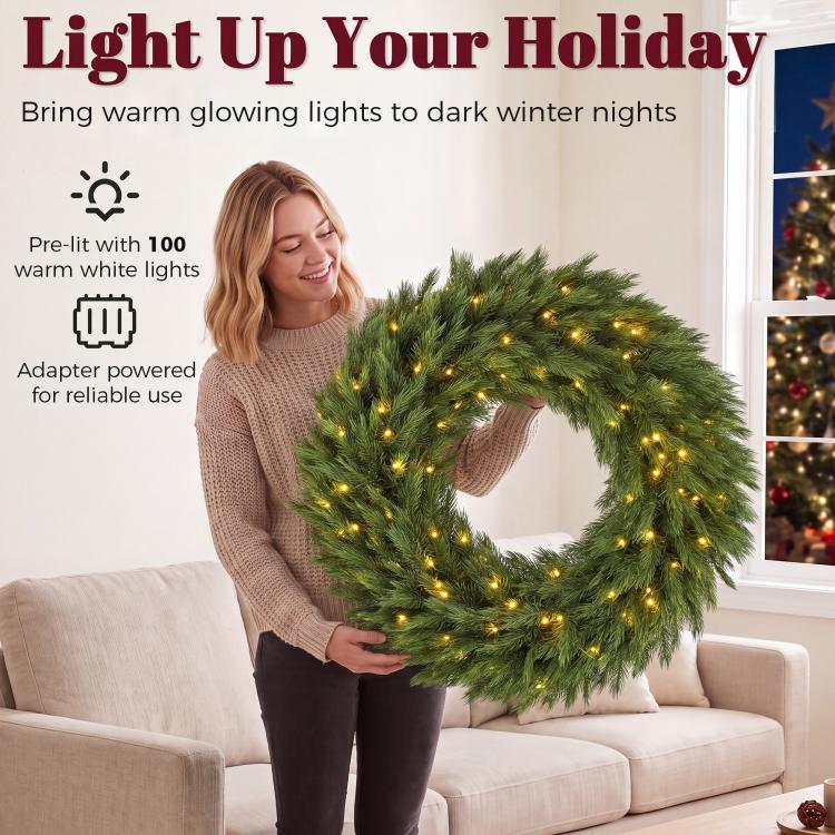 Green pre-lit artificial Christmas wreath with warm LED lights, circular evergreen ring
