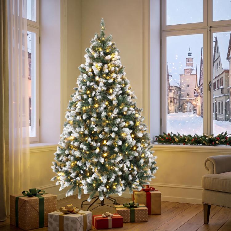 Artificial Christmas tree with hinged branches and warm white string lights, full height