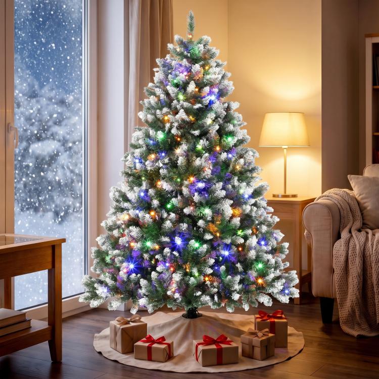 Frosted artificial Christmas tree with multicolor LED lights in a living room