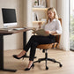 Brown mid-back computer chair with armrests, PU leather look seat and caster swivel base