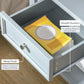 Light gray end table drawer with round metal knob and smooth runners