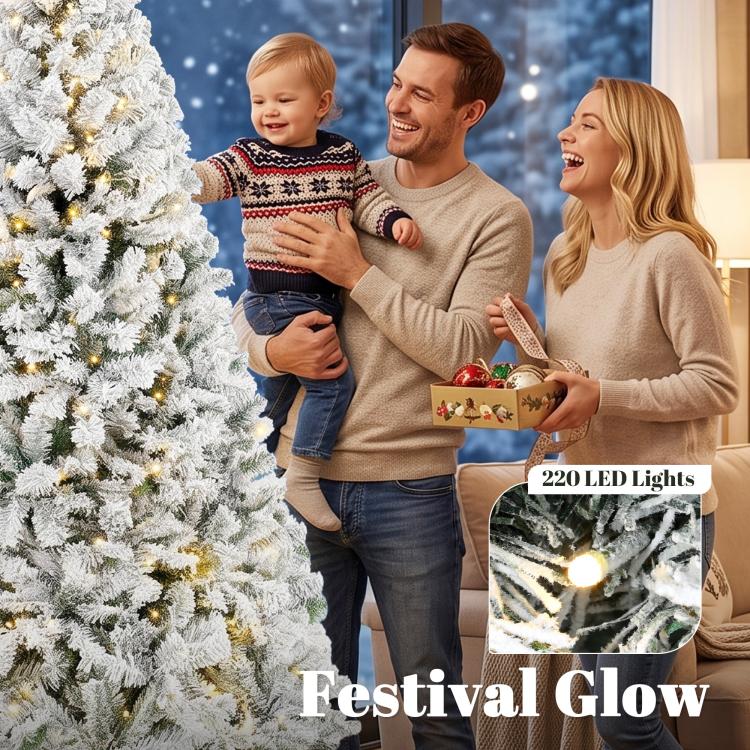 Snow-flocked Christmas tree with warm white lights, close view of branches