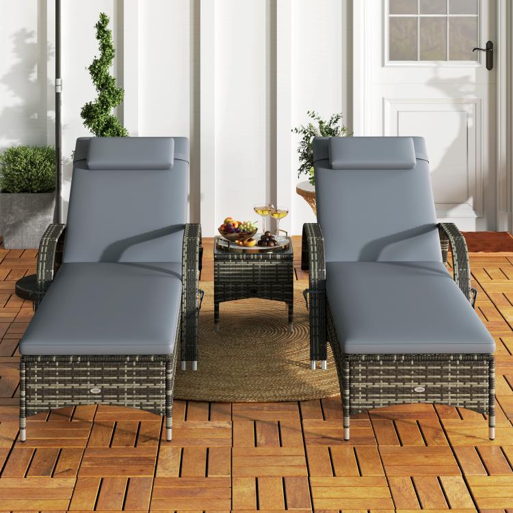 Outdoor wicker chaise lounge with gray cushion and curved woven base