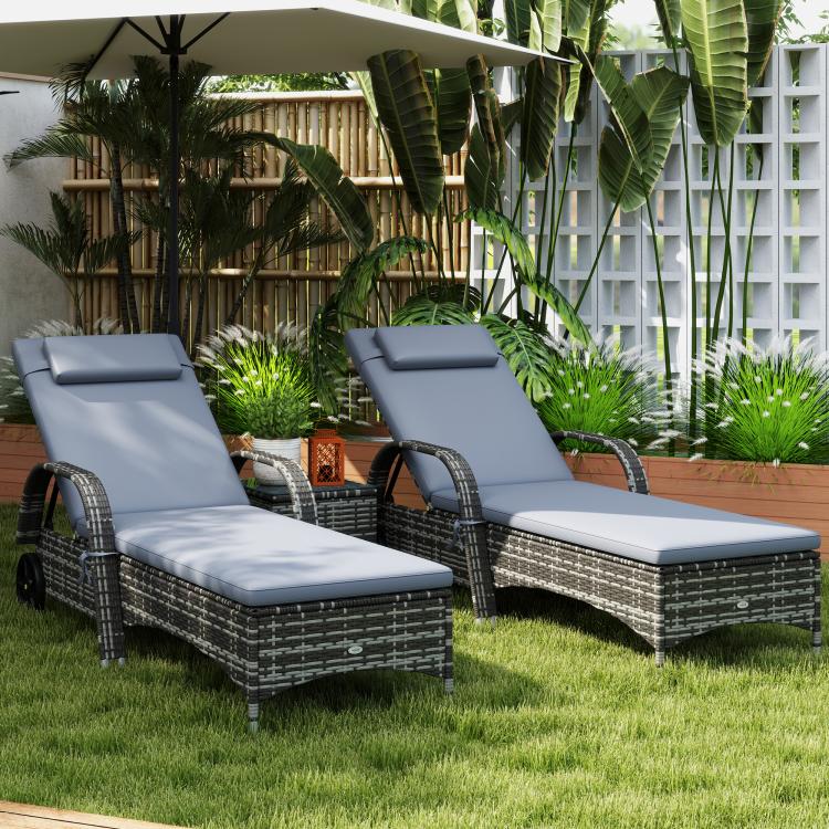 Three gray outdoor chaise lounges with dark wicker weave and square padded headrests