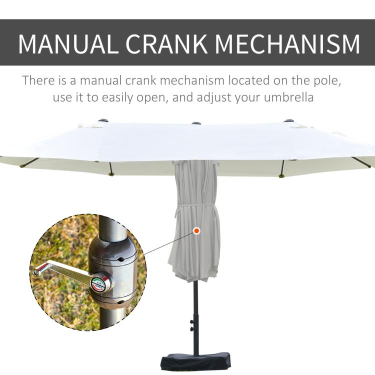 Patio umbrella with manual crank mechanism on pole and fabric cover hanging
