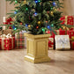 Prelit Christmas tree in gold planter with multicolor lights, close-up