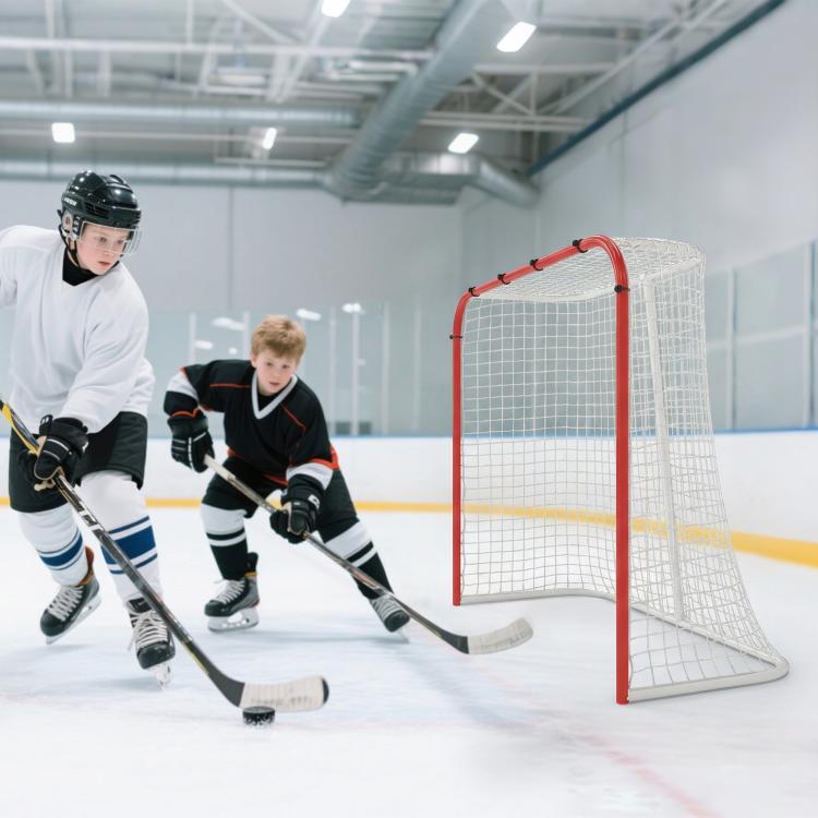 Indoor hockey goal with red frame and white mesh net in action