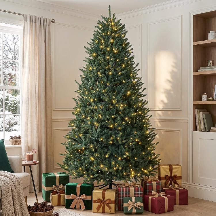 Tall artificial Christmas tree with green needles and warm white light strands