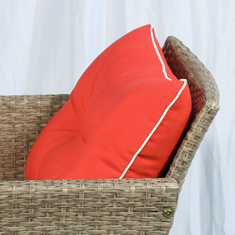 Brown wicker lounge chair with red seat and back cushion