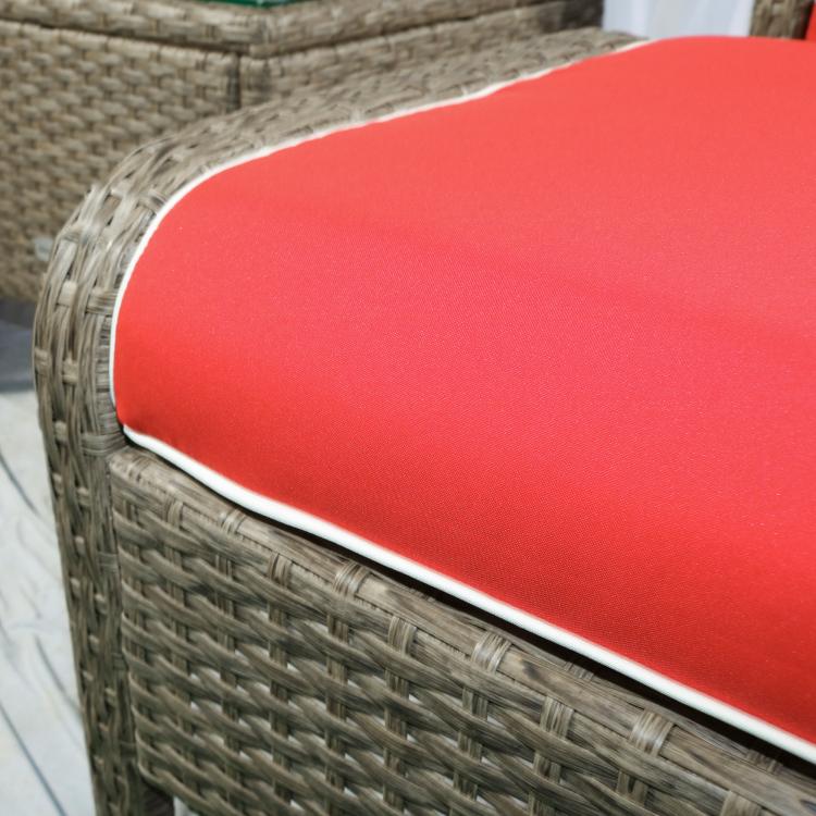 Close-up of red ottoman cushion edge with white piping on woven brown wicker
