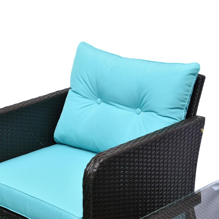 Close-up of teal cushion with tufted buttons on dark woven wicker lounge chair