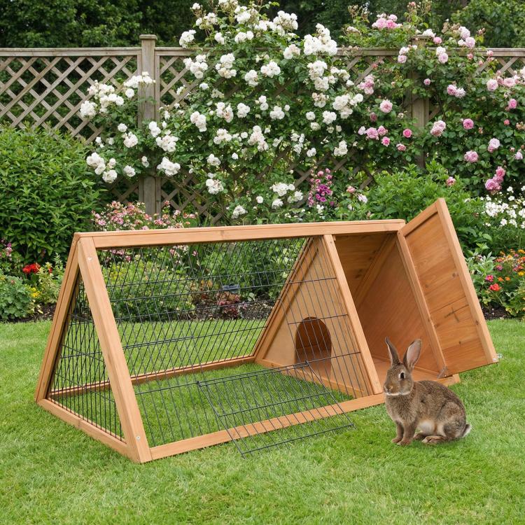 Outdoor brown wooden rabbit hutch with mesh run and hinged door, shown outdoors