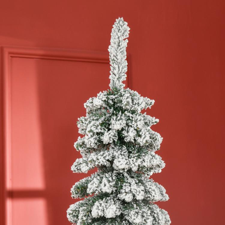 Snow-frosted artificial Christmas tree with dense branches, no decorations