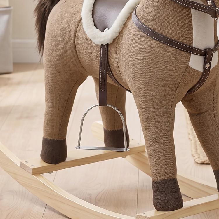 Brown fabric rocking horse toy with side harness and wooden base, close-up