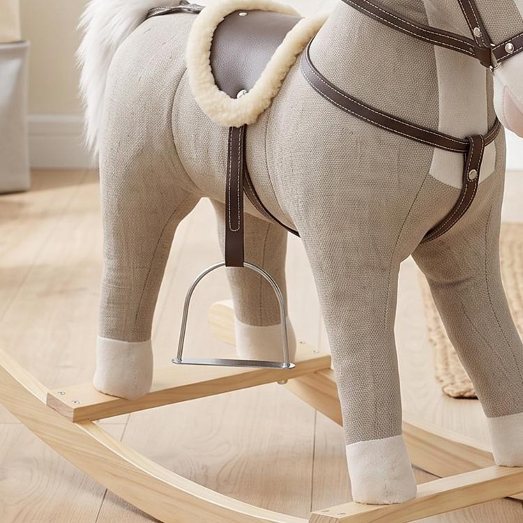 Gray plush rocking horse toy with brown saddle and harness, angled side view