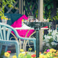 Verdigris bird bath basin with birds feeding, mounted on tall pedestal stand