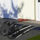 Wheelchair ramp with black non-slip panels and silver support rails extending outward