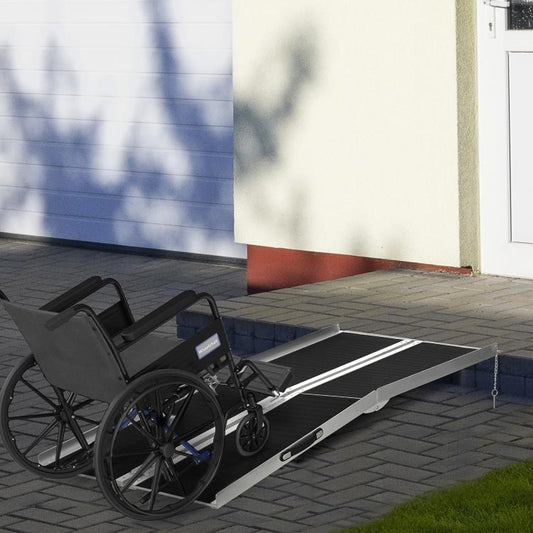 Wheelchair ramp with black non-slip panels and silver support rails extending outward