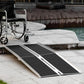 Wheelchair ramp with black grip tread and silver fold-out legs for step access